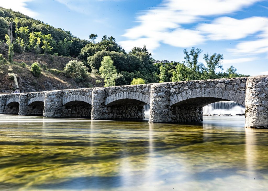 gray concrete bridge over river during daytime